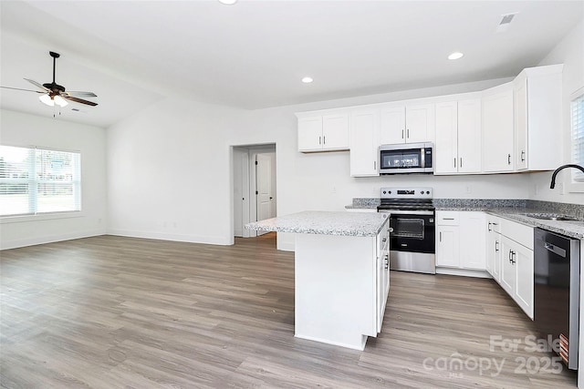 2365 28th St NE, Hickory, NC 28601 - kitchen featuring a ceiling fan, lofted ceiling, a center island, a sink, and appliances with stainless steel finishes