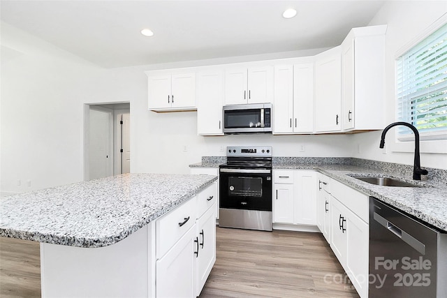 2365 28th St NE, Hickory, NC 28601 - kitchen featuring a sink, appliances with stainless steel finishes, light stone counters, recessed lighting, and light wood-style floors