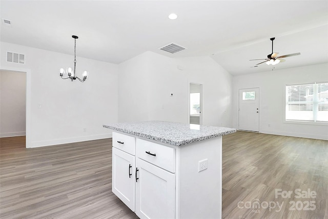 2365 28th St NE, Hickory, NC 28601 - kitchen featuring a kitchen island, open floor plan, visible vents, light wood-style floors, and vaulted ceiling