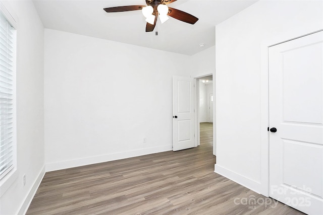 2365 28th St NE, Hickory, NC 28601 - unfurnished bedroom featuring ceiling fan, baseboards, and light wood-type flooring
