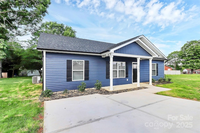 2365 28th St NE, Hickory, NC 28601 - view of front of home with central AC, a front yard, and a shingled roof