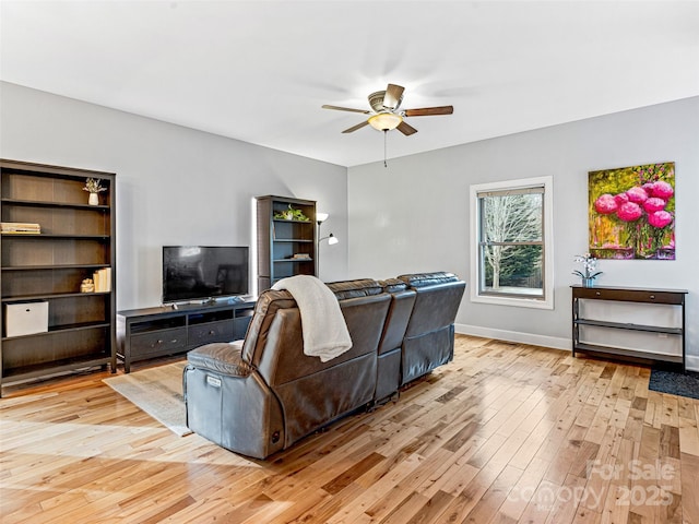 living room featuring light hardwood / wood-style floors and ceiling fan