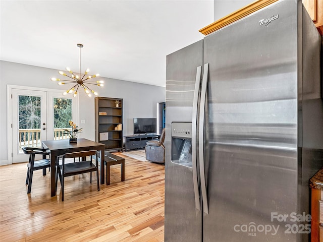 kitchen featuring a chandelier, stainless steel refrigerator with ice dispenser, and light hardwood / wood-style flooring