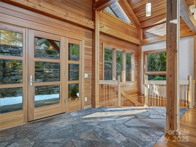 unfurnished sunroom with lofted ceiling and wood ceiling