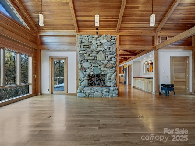 unfurnished living room featuring wooden ceiling, a fireplace, hardwood / wood-style floors, and high vaulted ceiling