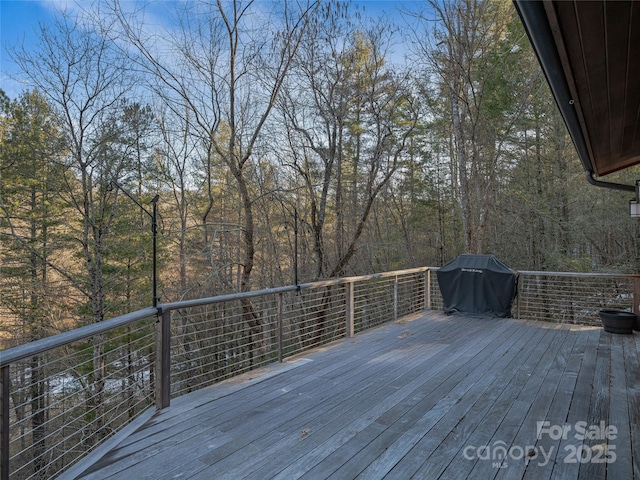 wooden deck featuring area for grilling