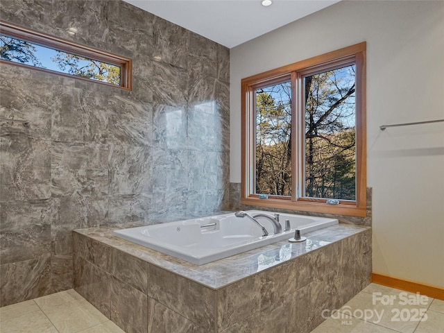 bathroom with tile patterned floors and tiled tub