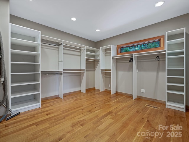 spacious closet featuring hardwood / wood-style flooring