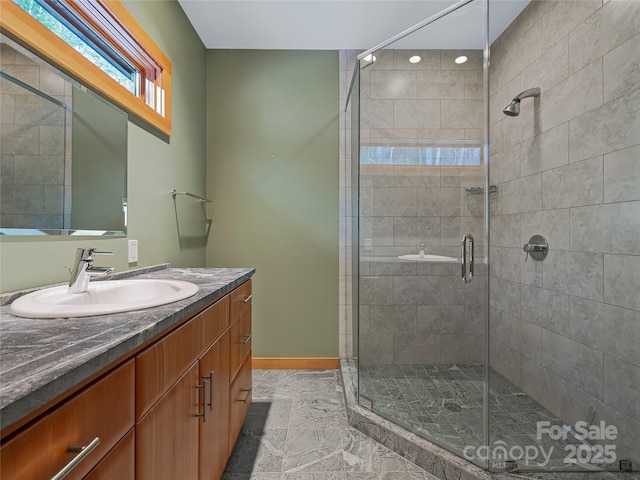 bathroom with walk in shower and vanity