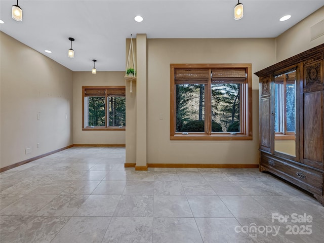 unfurnished room featuring a wealth of natural light