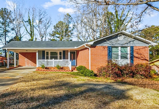 ranch-style home with a front yard, a porch, and a carport