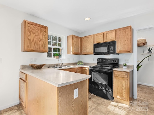 kitchen with kitchen peninsula, sink, and black appliances