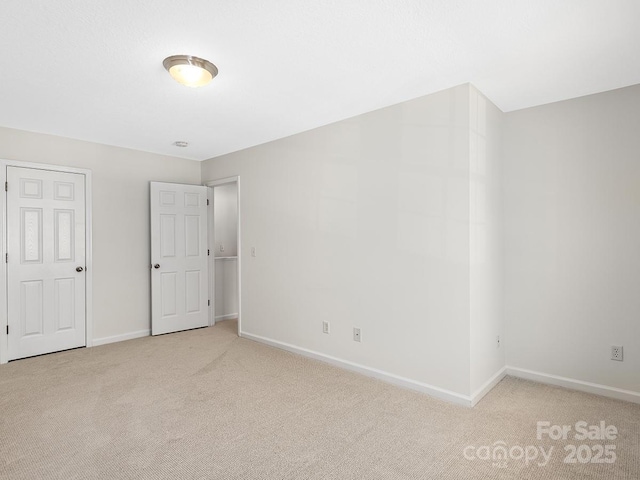 unfurnished bedroom featuring light carpet