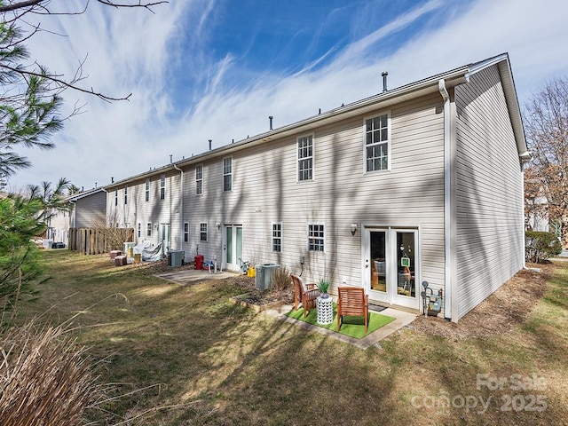 back of house with a patio, a yard, and central air condition unit