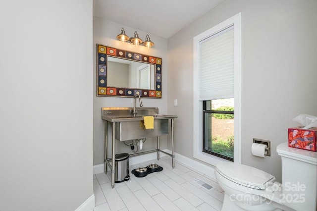 bathroom with tile patterned floors and toilet