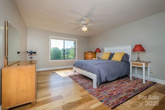 bedroom with light hardwood / wood-style floors and ceiling fan