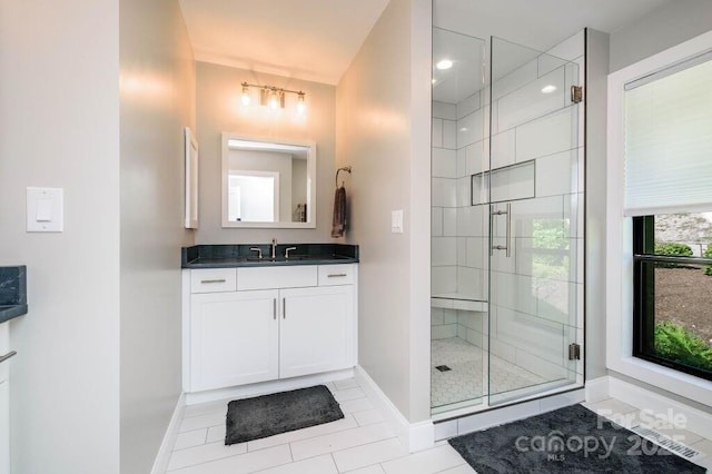 bathroom featuring tile patterned floors, vanity, and walk in shower