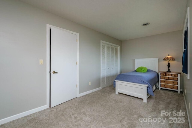 carpeted bedroom featuring a closet