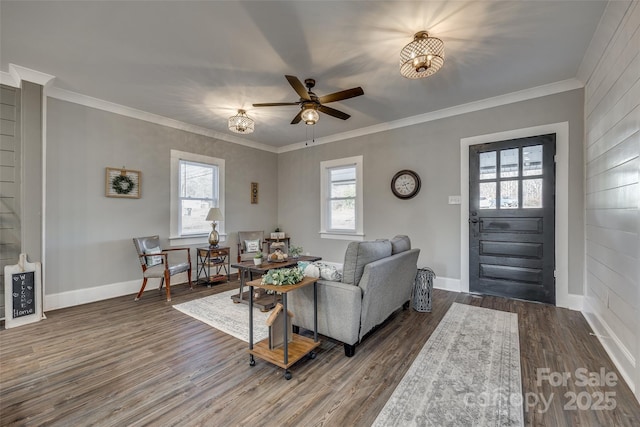 living room with ceiling fan, crown molding, a wealth of natural light, and dark hardwood / wood-style floors