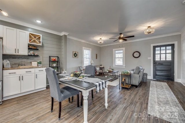 dining room with ceiling fan, hardwood / wood-style flooring, and ornamental molding