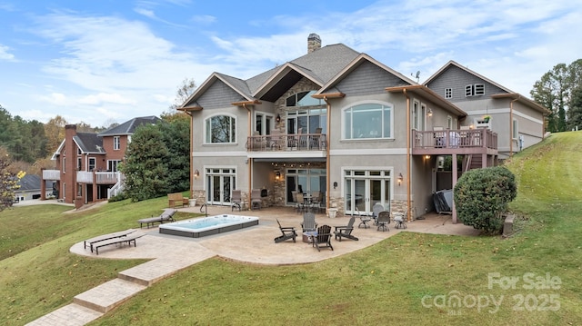 back of house featuring a patio area, a yard, french doors, and an outdoor fire pit