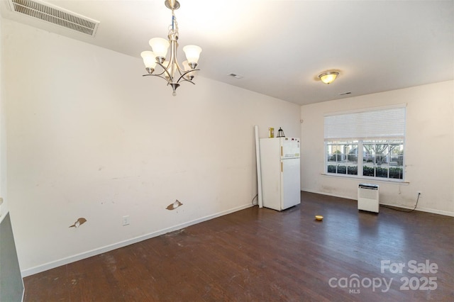 interior space featuring a notable chandelier and dark wood-type flooring