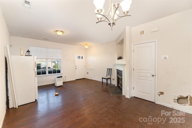 interior space with a chandelier and dark wood-type flooring