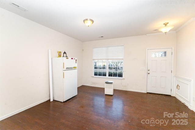 kitchen with white refrigerator and dark wood-type flooring