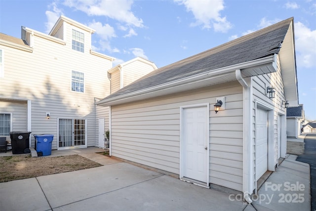 back of property featuring a garage