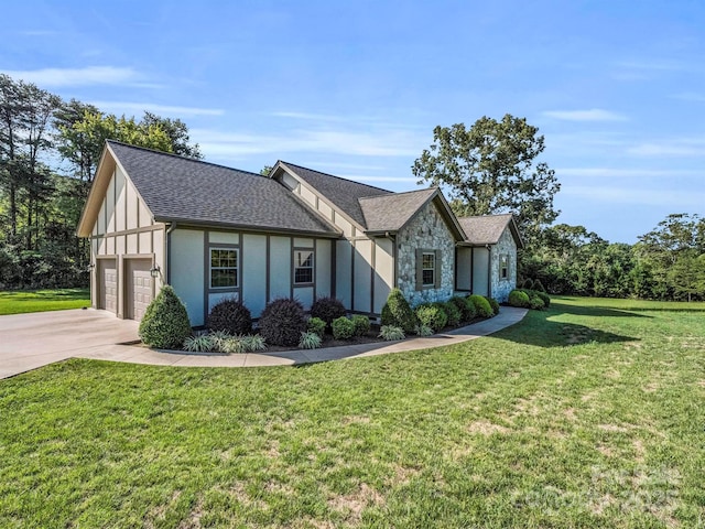 english style home with a garage and a front yard