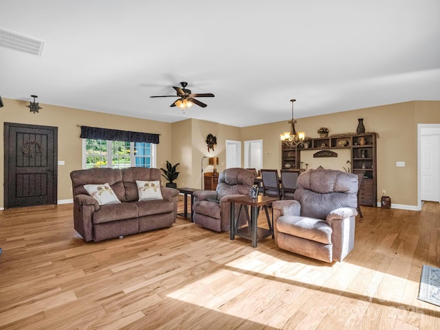 living room featuring light hardwood / wood-style flooring and ceiling fan with notable chandelier