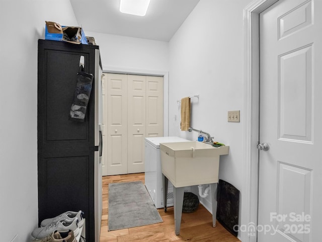 laundry area featuring light hardwood / wood-style floors