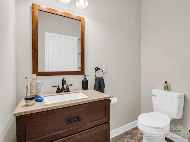 bathroom featuring tile patterned flooring, vanity, and toilet