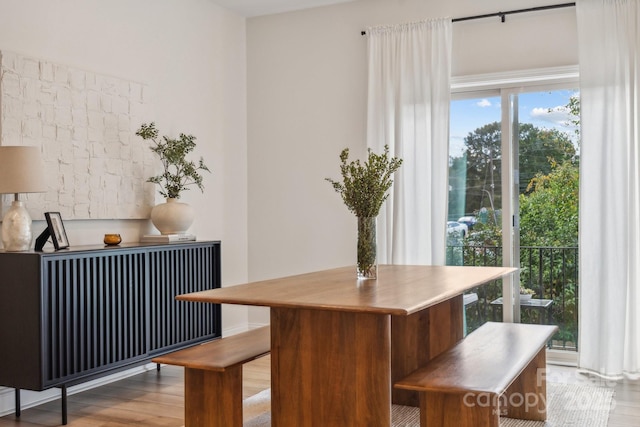 dining space featuring radiator heating unit and light wood-type flooring