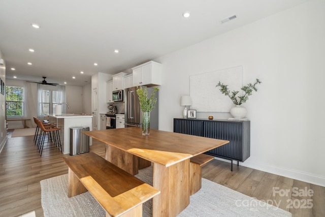 dining room featuring light hardwood / wood-style floors and ceiling fan