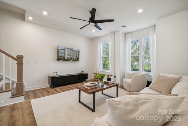 living room with hardwood / wood-style floors and ceiling fan