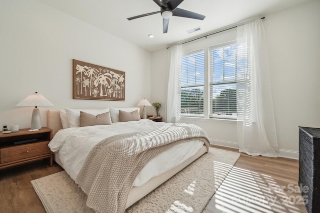 bedroom featuring ceiling fan and dark wood-type flooring