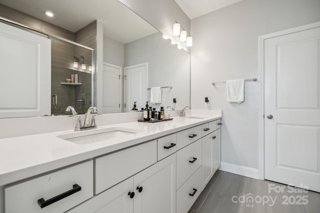 bathroom with an enclosed shower and vanity