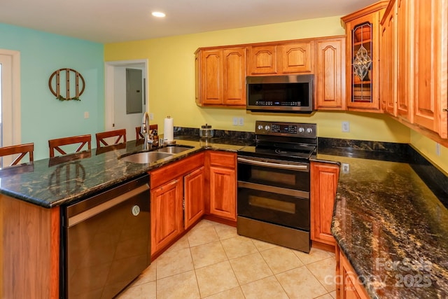 kitchen featuring sink, kitchen peninsula, stainless steel appliances, and light tile patterned floors