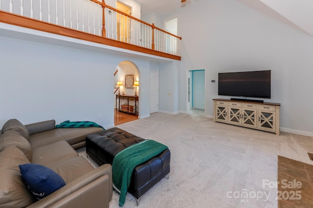 carpeted living room featuring a high ceiling