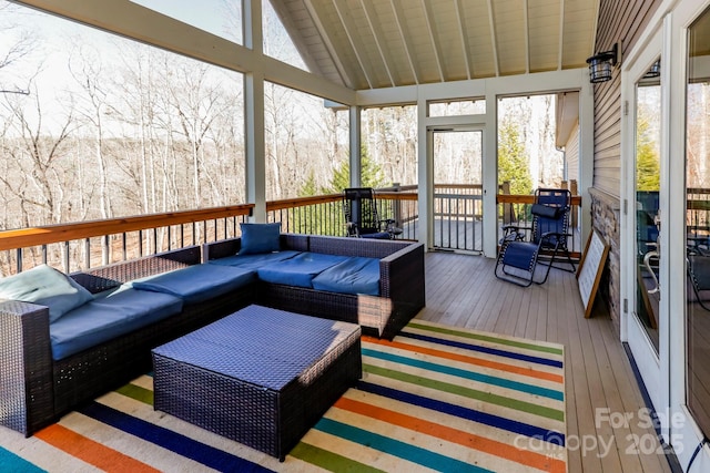 sunroom / solarium featuring vaulted ceiling