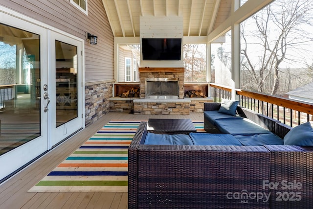 wooden deck featuring an outdoor living space with a fireplace and french doors