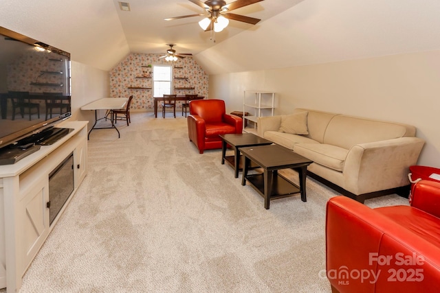 carpeted living room featuring vaulted ceiling and ceiling fan