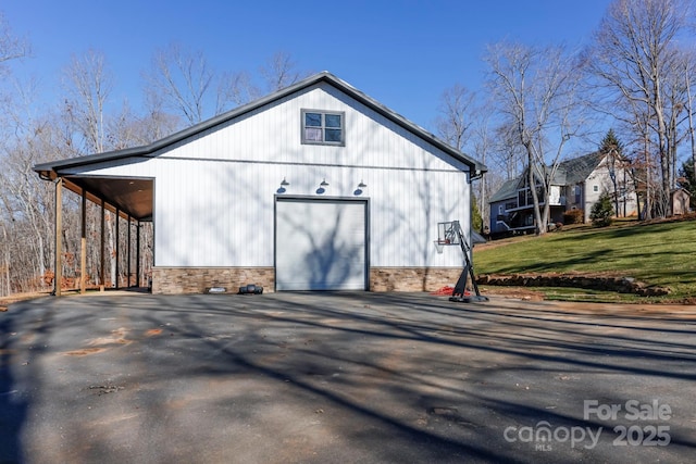 view of outbuilding with a garage and a lawn