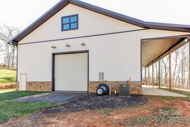 exterior space featuring a garage and central air condition unit