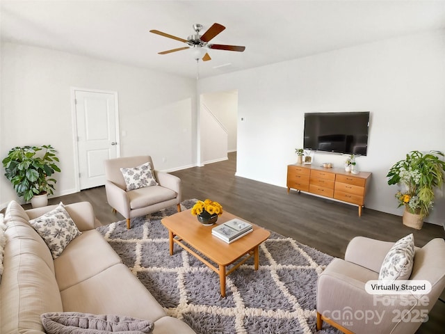 living room with ceiling fan and dark hardwood / wood-style flooring