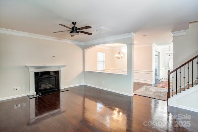 unfurnished living room with crown molding, dark hardwood / wood-style flooring, and ceiling fan with notable chandelier