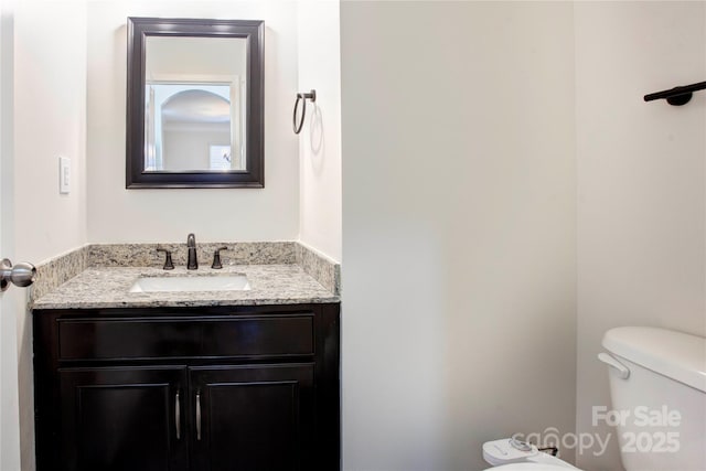 bathroom with vanity and toilet