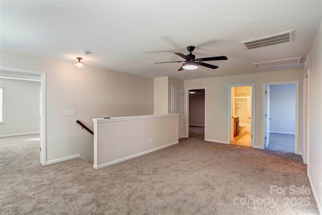 unfurnished room with light carpet and ceiling fan