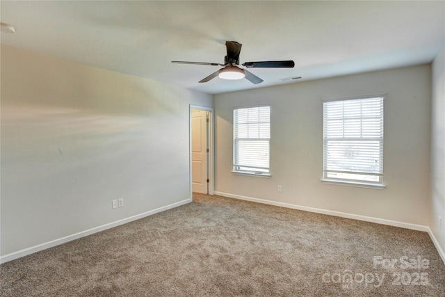 empty room featuring light colored carpet and ceiling fan